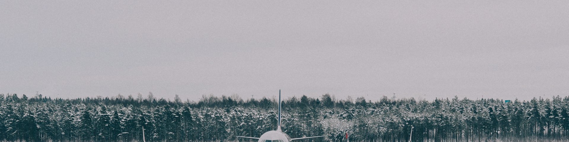 Asphalt runway with a plane parked on to that was lay by tarmac contractors