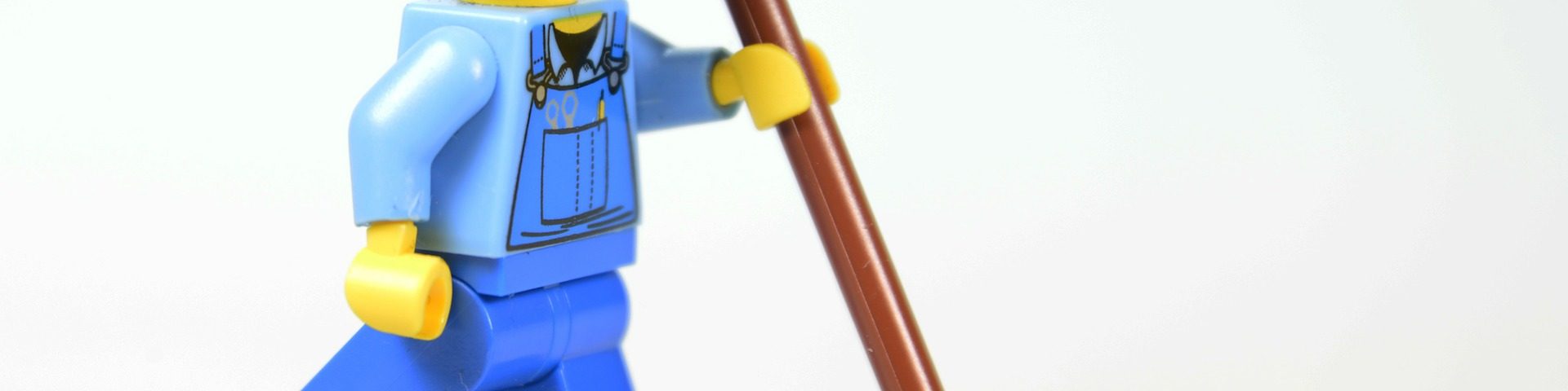 A lego man helping with commercial cleaning services.